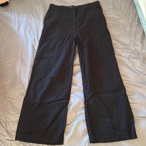 Black trousers, no name, said size L but normal size XS fits (thailand made)